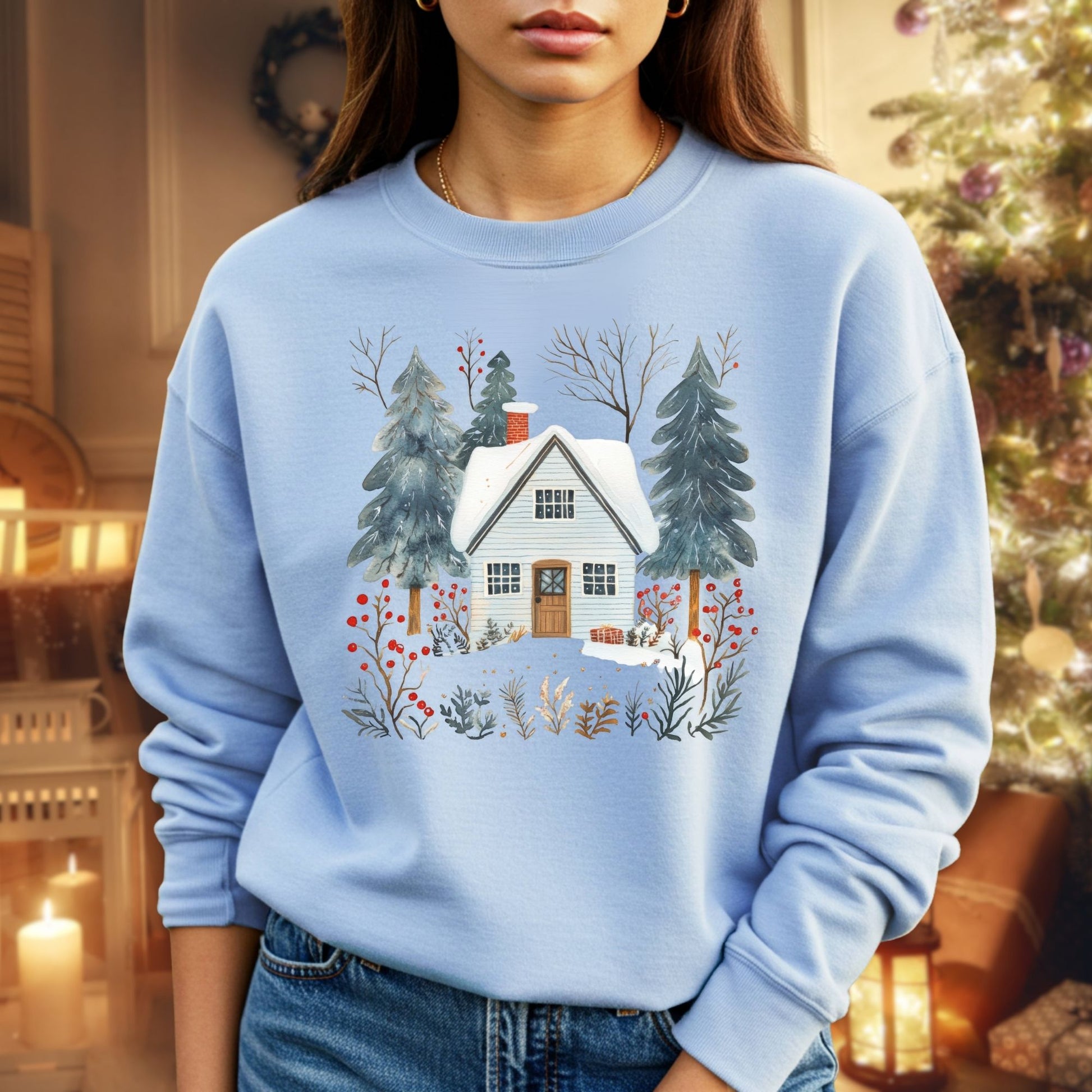 Light blue crewneck sweatshirt with a snowy Nordic cabin, pine trees, and red berries.
