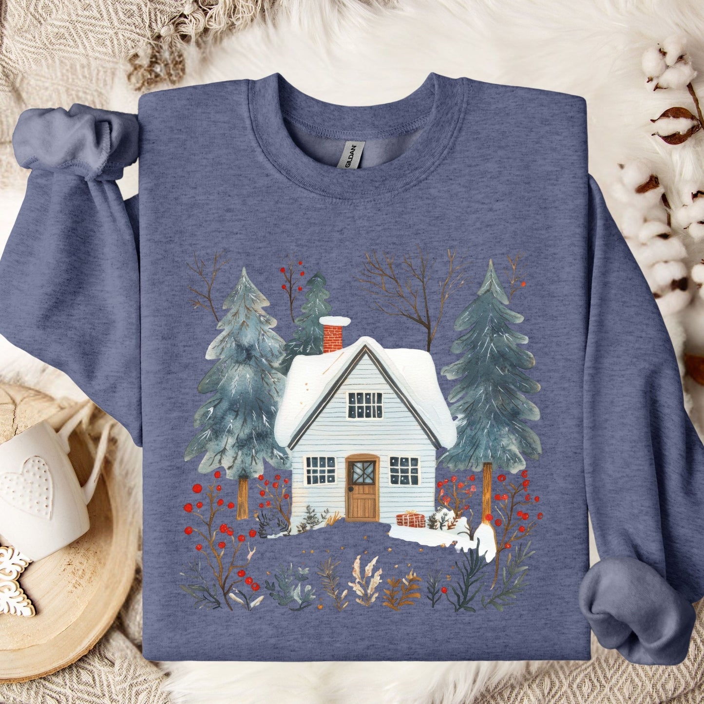 Heather Sport Dark Navy crewneck sweatshirt with a snowy cabin and pine trees in a folk-art style.