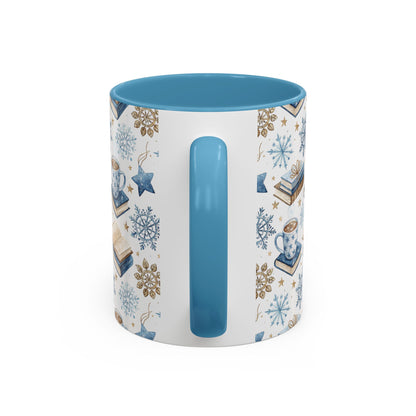White ceramic mug with blue handle and interior, featuring a Nordic winter watercolor design of cocoa, books, and snowflakes.