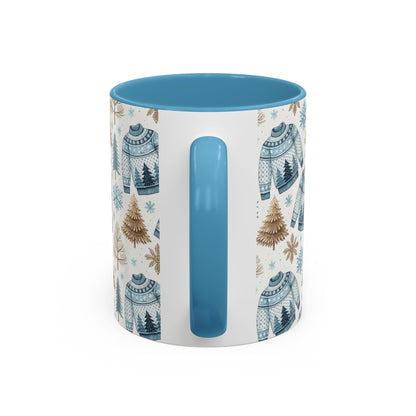 Nordic Winter Fair Isle sweater mug with blue handle and interior, featuring watercolor snowflakes and evergreens.