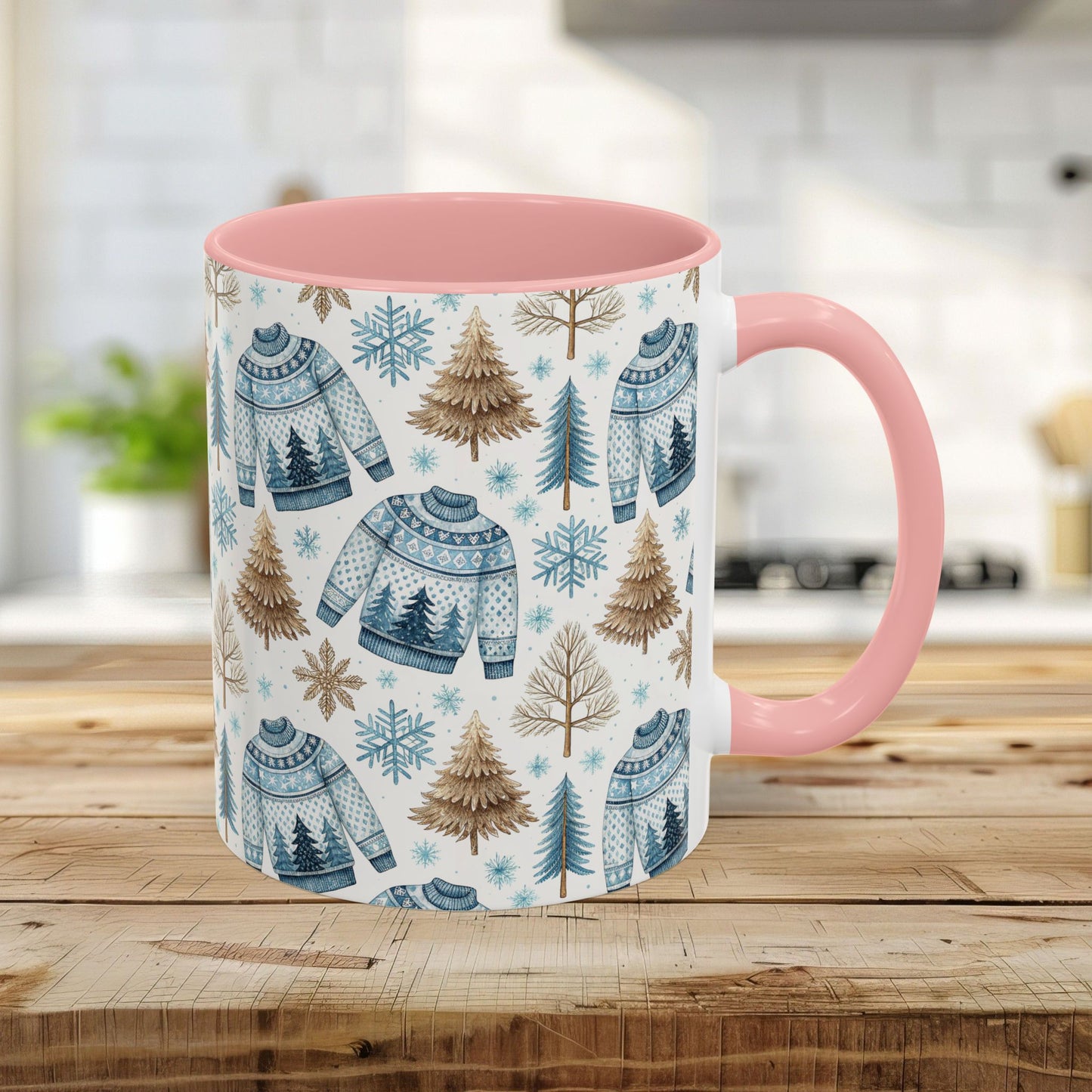11oz Nordic Winter Fair Isle mug with blue sweaters, snowflakes, and tan evergreens, featuring a pink handle and interior.