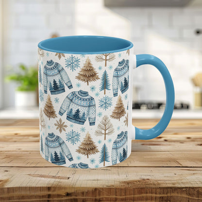 11oz Nordic Winter Fair Isle mug with blue handle & interior, featuring watercolor sweaters, snowflakes, and evergreens.