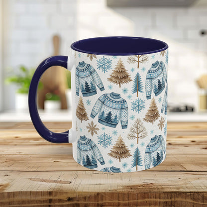 Nordic Winter Fair Isle sweater mug with blue handle and interior, featuring watercolor trees and snowflakes.