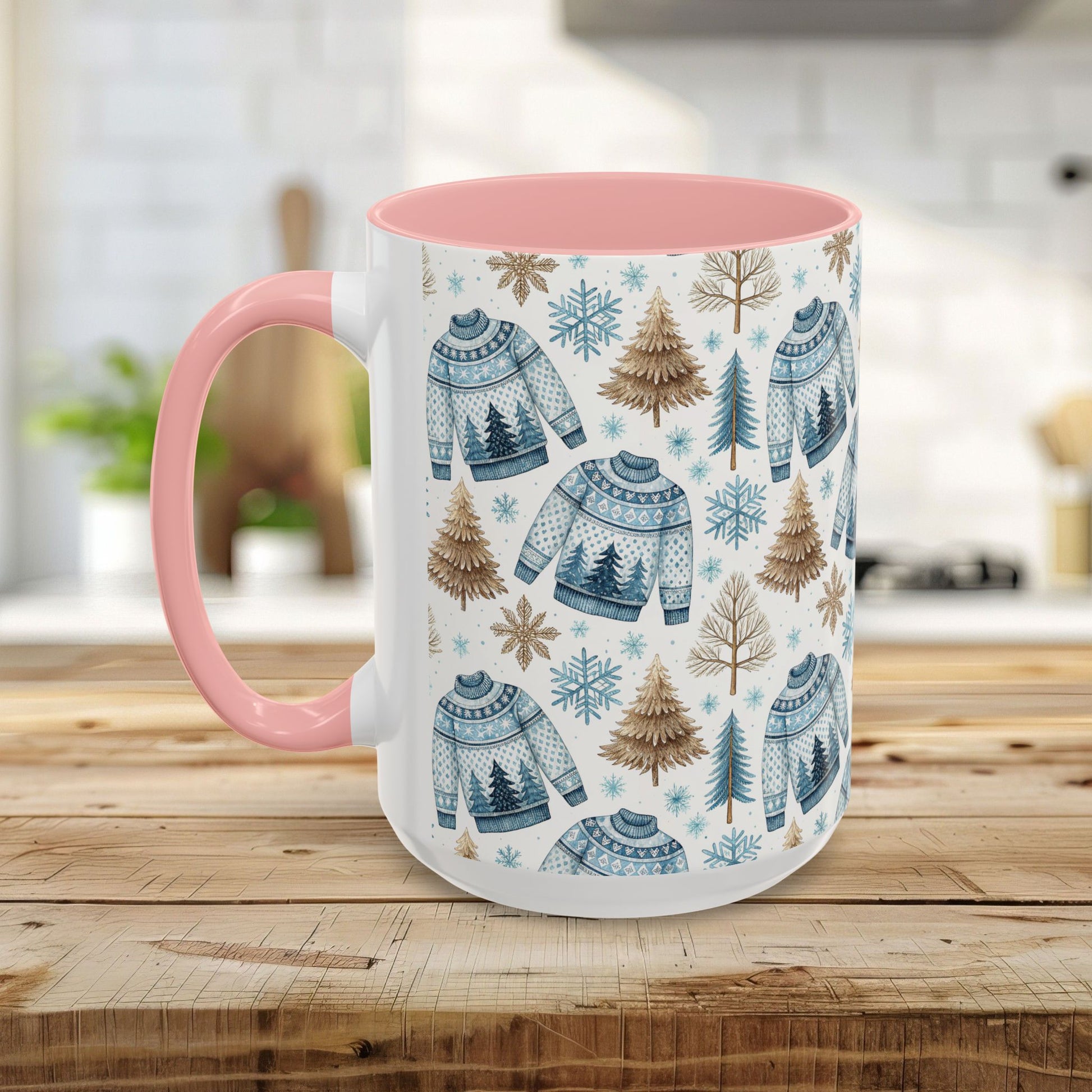 White ceramic mug with a pink handle and interior, featuring a watercolor Nordic fair isle sweater, snowflake, and evergreen tree pattern.