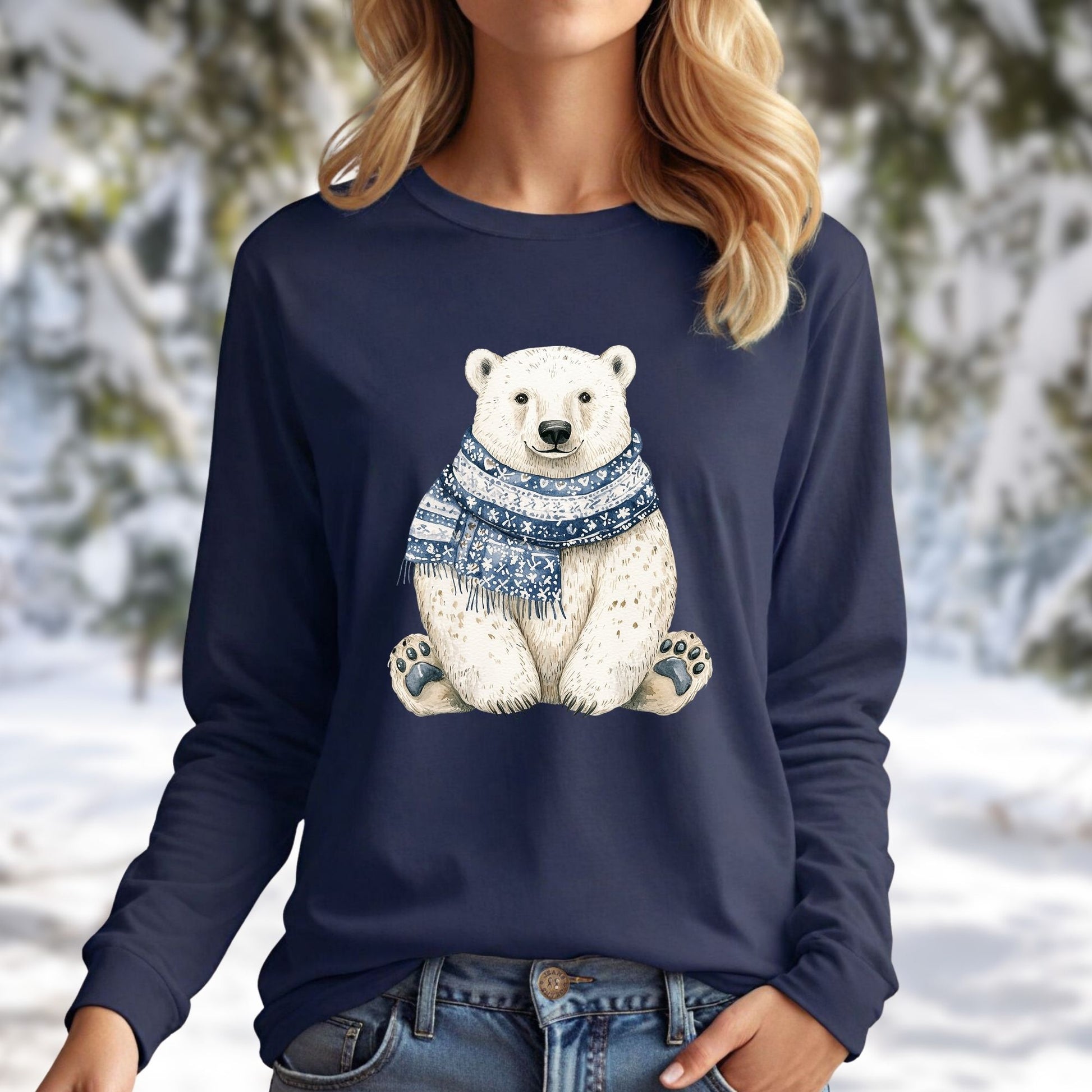 Navy long-sleeve tee with a hand-painted polar bear wearing a blue and white knitted scarf, set against a snowy background.