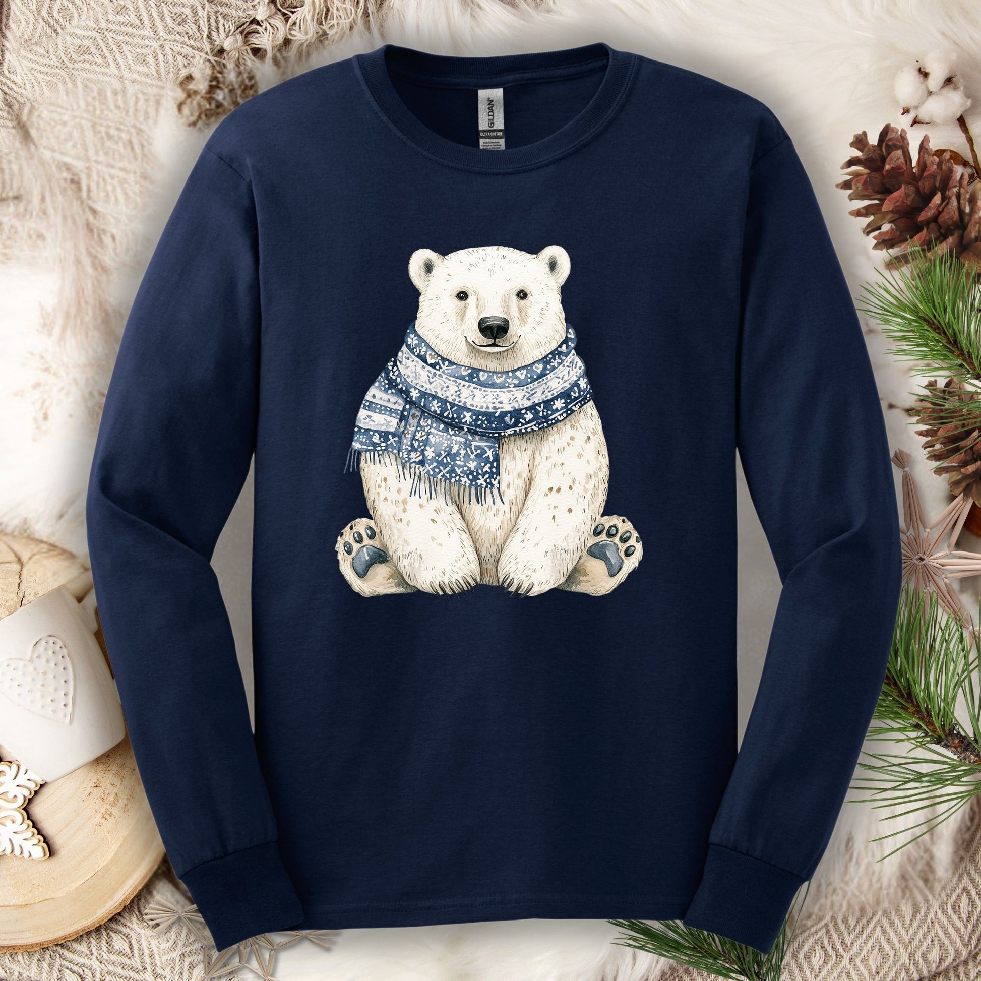 Navy long-sleeve cotton tee with a hand-painted polar bear wearing a blue knitted scarf.