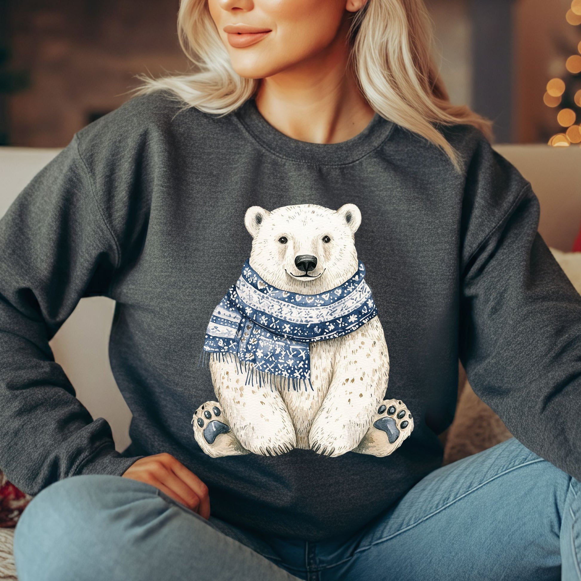 Blonde woman wearing a charcoal gray sweatshirt with a friendly polar bear in a blue patterned scarf.