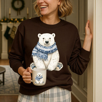 Woman in a brown Nordic Winter Polar Bear Sweatshirt with a blue patterned scarf, holding a matching mug.