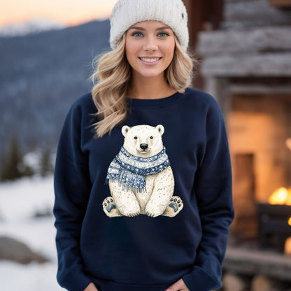 Woman in navy sweatshirt with a detailed polar bear wearing a blue patterned scarf, white beanie, snowy background.