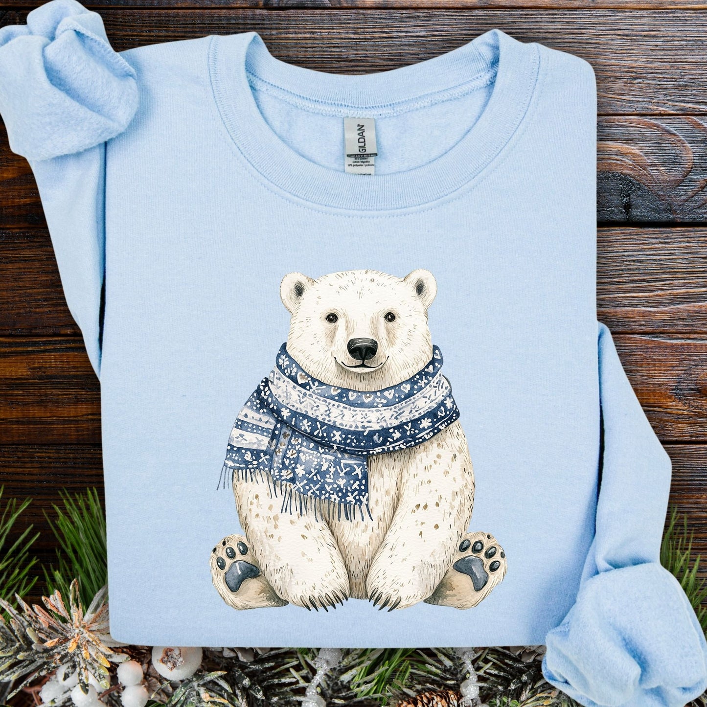 Light blue Nordic Winter Polar Bear Sweatshirt with a sitting bear wearing a blue patterned scarf.