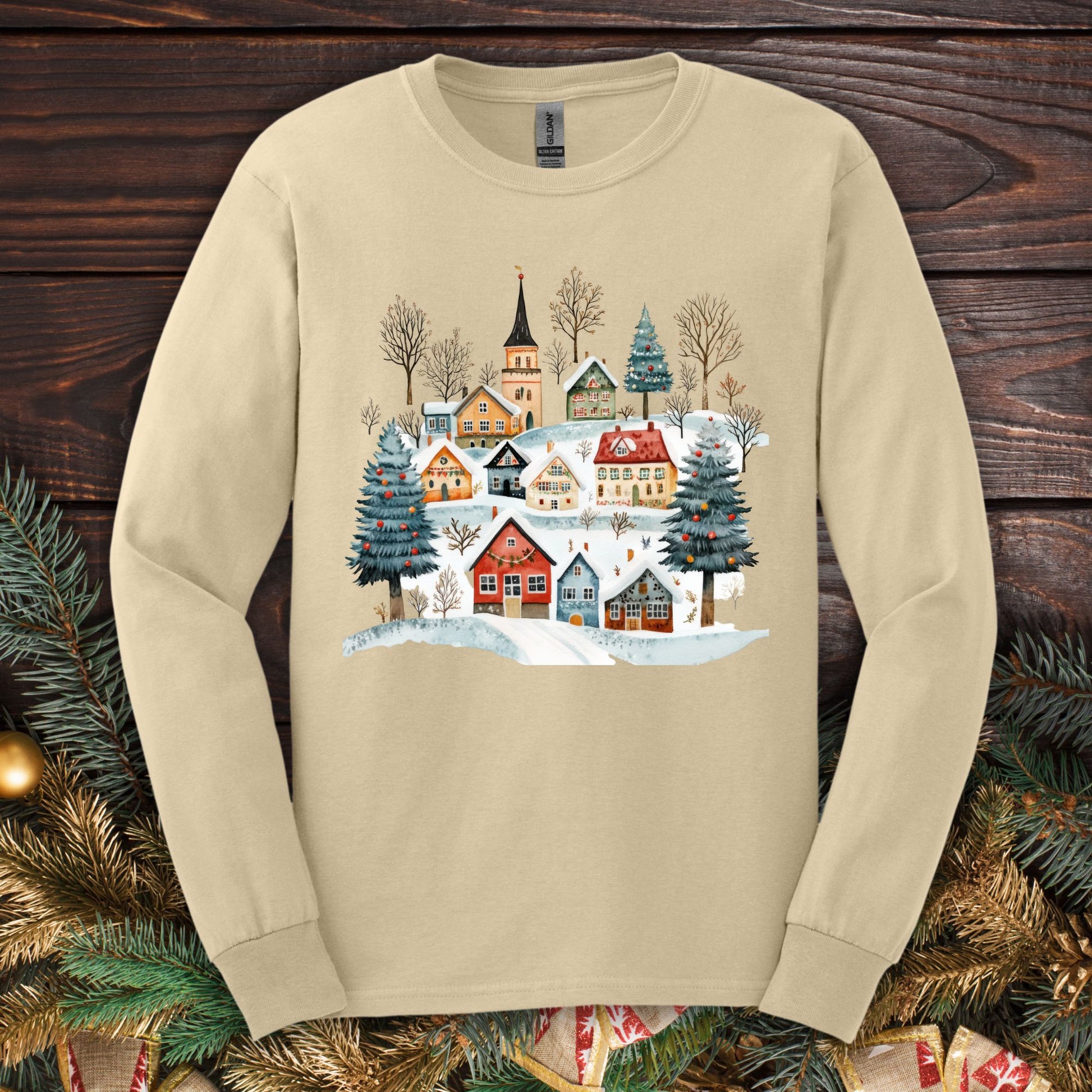 Sand Gildan Softstyle long sleeve tee with a watercolor Nordic winter village design.