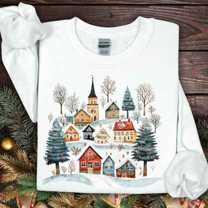 White Nordic Winter Village sweatshirt with folk-art cottages, trees, and snow.