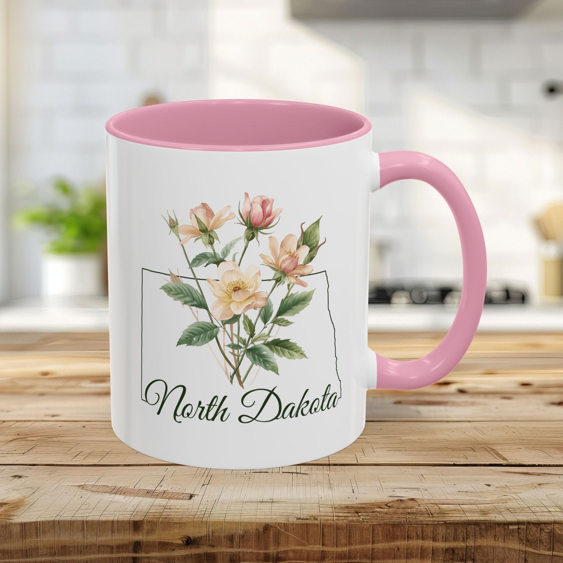 11oz ceramic mug with pink handle and interior, featuring watercolor wild prairie roses inside a North Dakota outline.