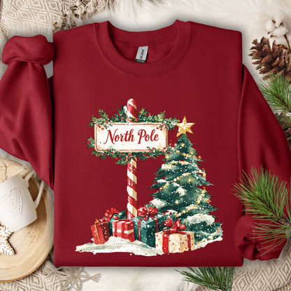 Cardinal Red Gildan sweatshirt with a watercolor North Pole sign, Christmas tree, and gifts.