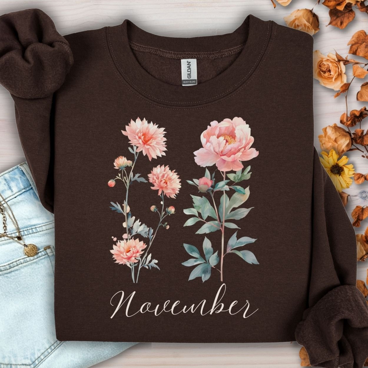 Dark chocolate unisex sweatshirt with watercolor chrysanthemum and peony flowers, "November" text, and autumn leaves.
