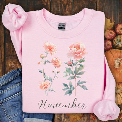 Light pink crewneck sweatshirt with watercolor chrysanthemum and peony flowers, plus "November" text.