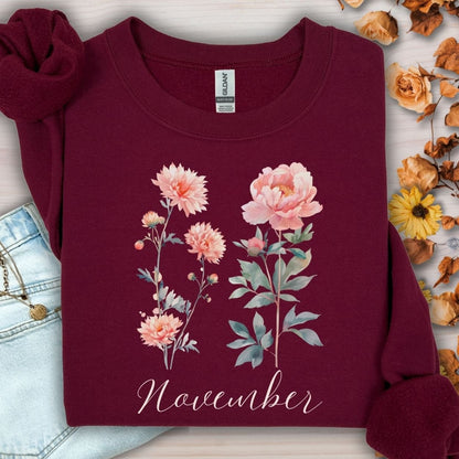 Maroon unisex sweatshirt with watercolor chrysanthemum and peony flowers, plus "November" text.