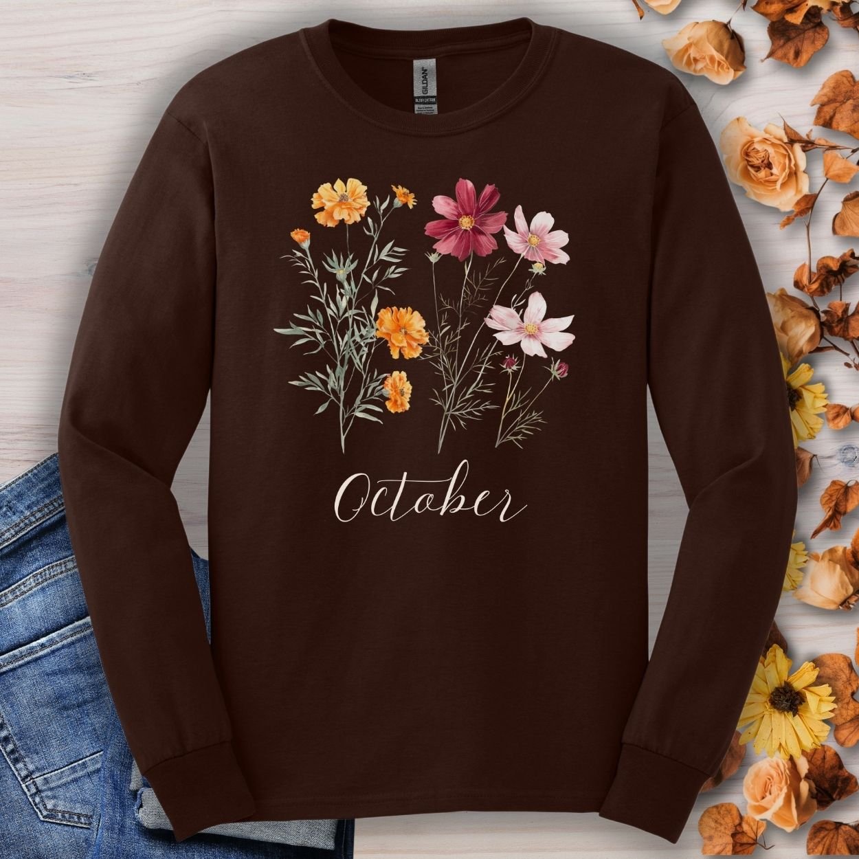 Dark chocolate long sleeve tee with watercolor marigolds, cosmos, and "October" script.