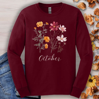 Maroon long sleeve tee with watercolor marigold and cosmos flowers and "October" text.