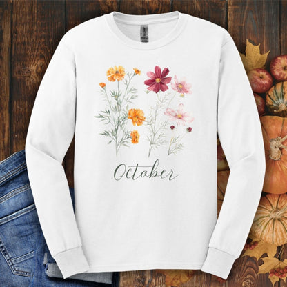White long sleeve tee with watercolor marigold and cosmos flowers, "October" script, and autumn decor.