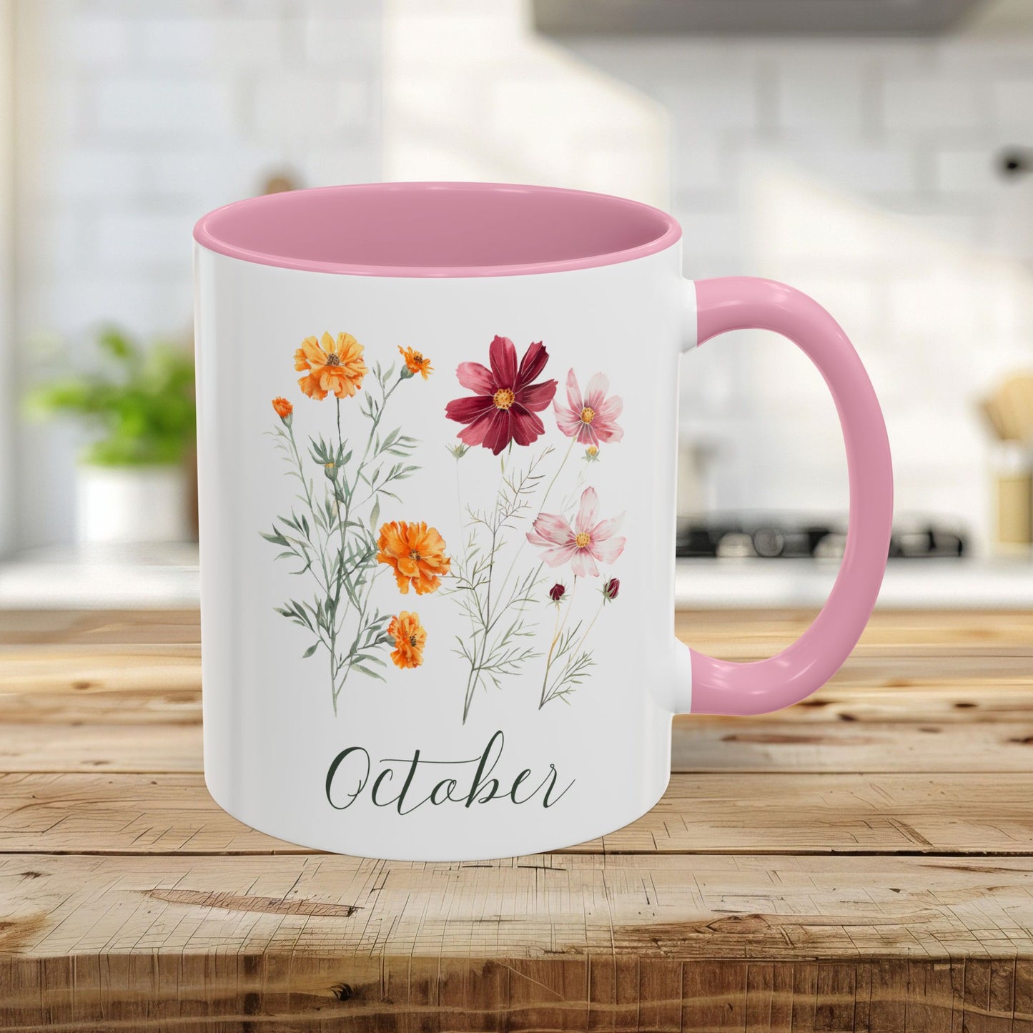 11oz ceramic mug with pink handle/interior, featuring watercolor cosmos and marigold blooms, and "October" script.