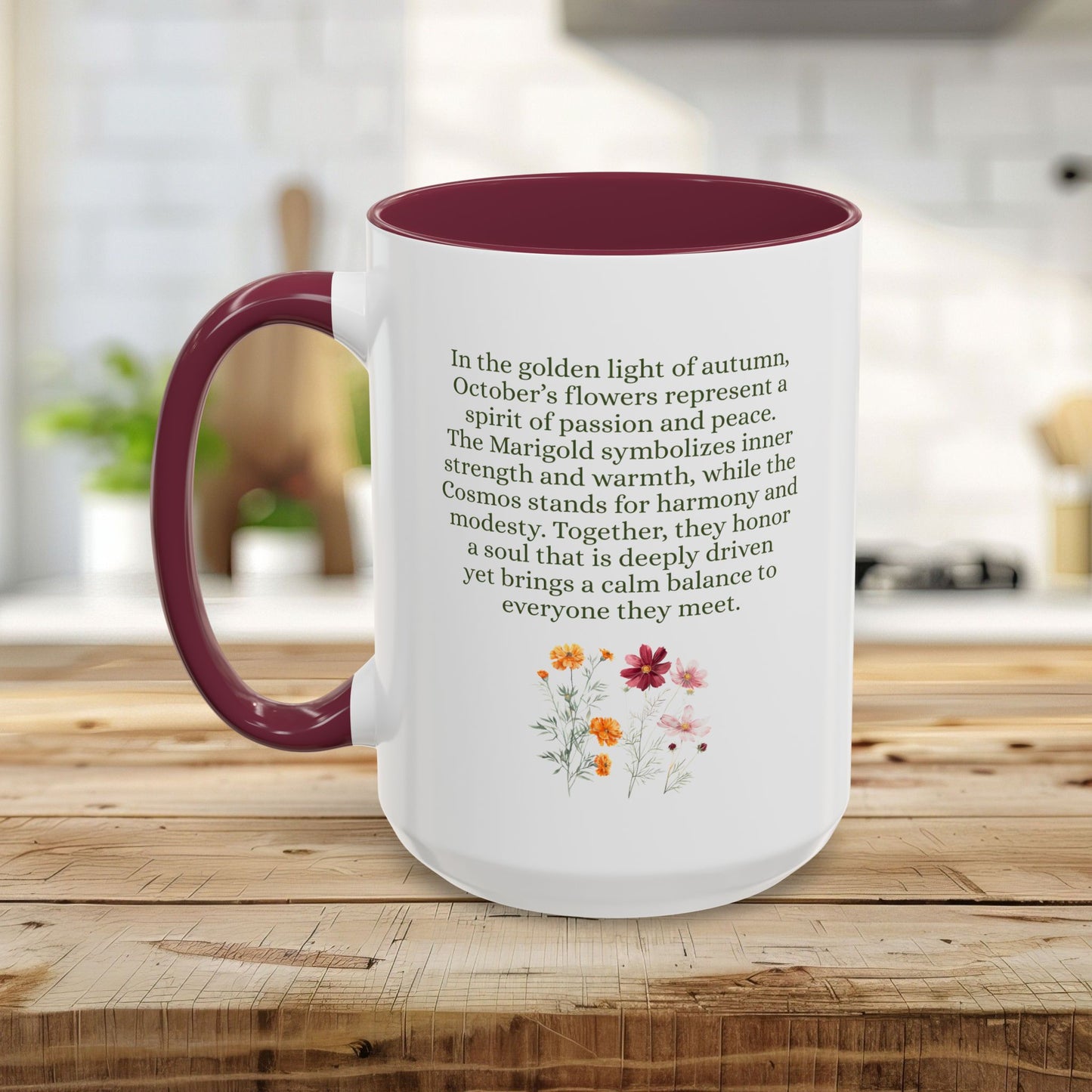 White ceramic mug with a burgundy handle and interior, featuring October birth month flower text and cosmos and marigold art.