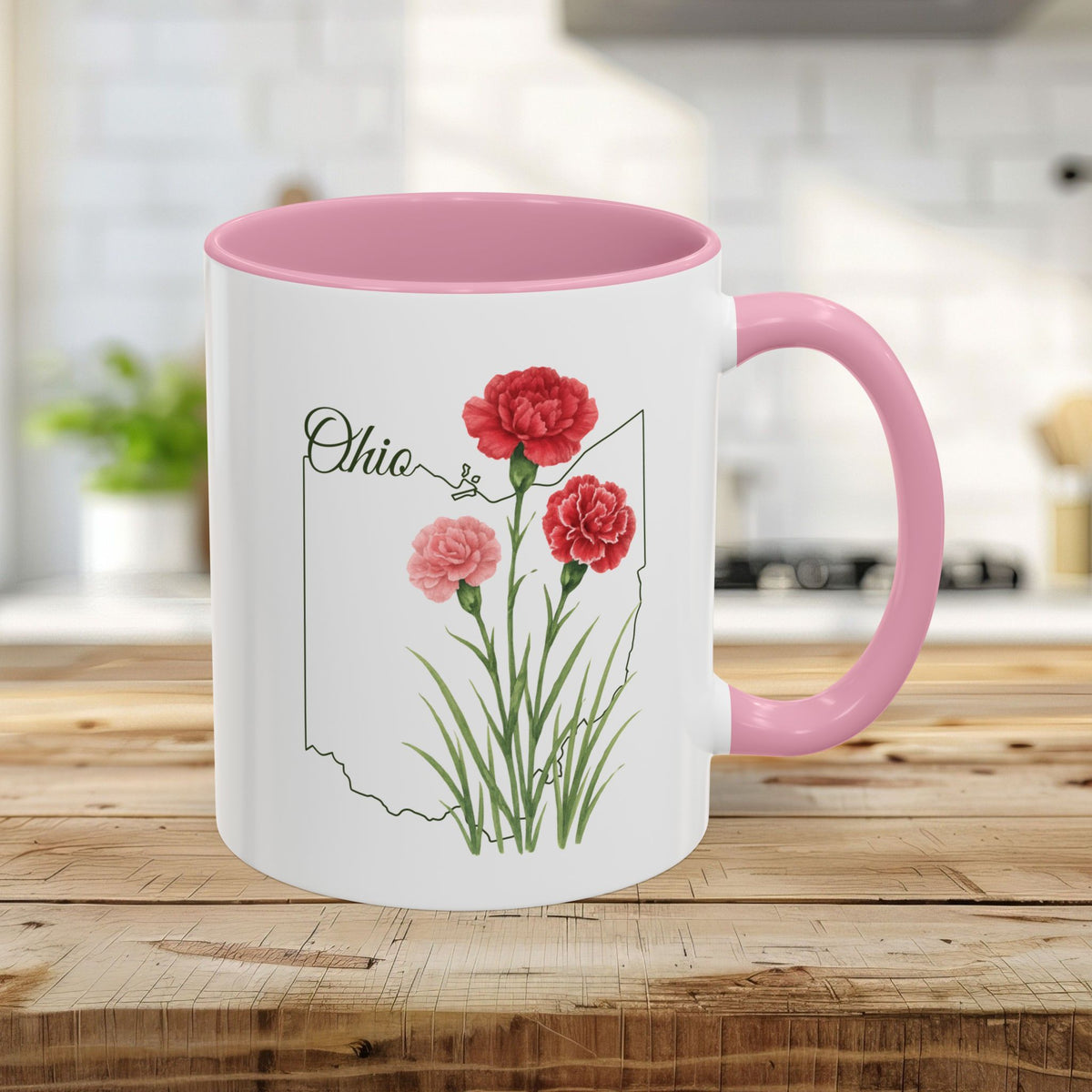 White ceramic 11oz mug with pink interior/handle, featuring Ohio state outline and scarlet carnation watercolor print.