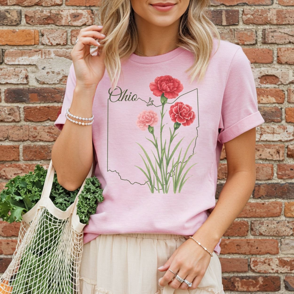 Relaxed-fit, garment-dyed pink t-shirt with red and pink carnations layered over an Ohio outline.