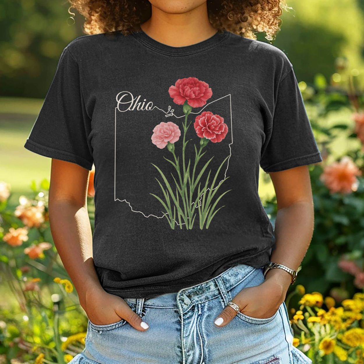 Relaxed-fit, garment-dyed black t-shirt with red and pink carnations layered over an Ohio outline.