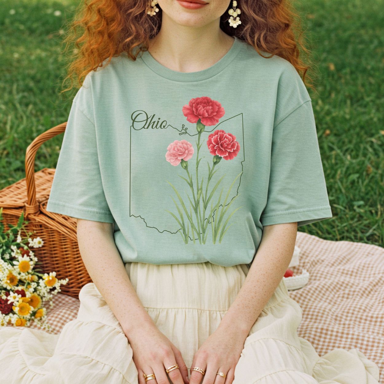 Garment-dyed sage green t-shirt with red and pink carnations layered over an Ohio outline.