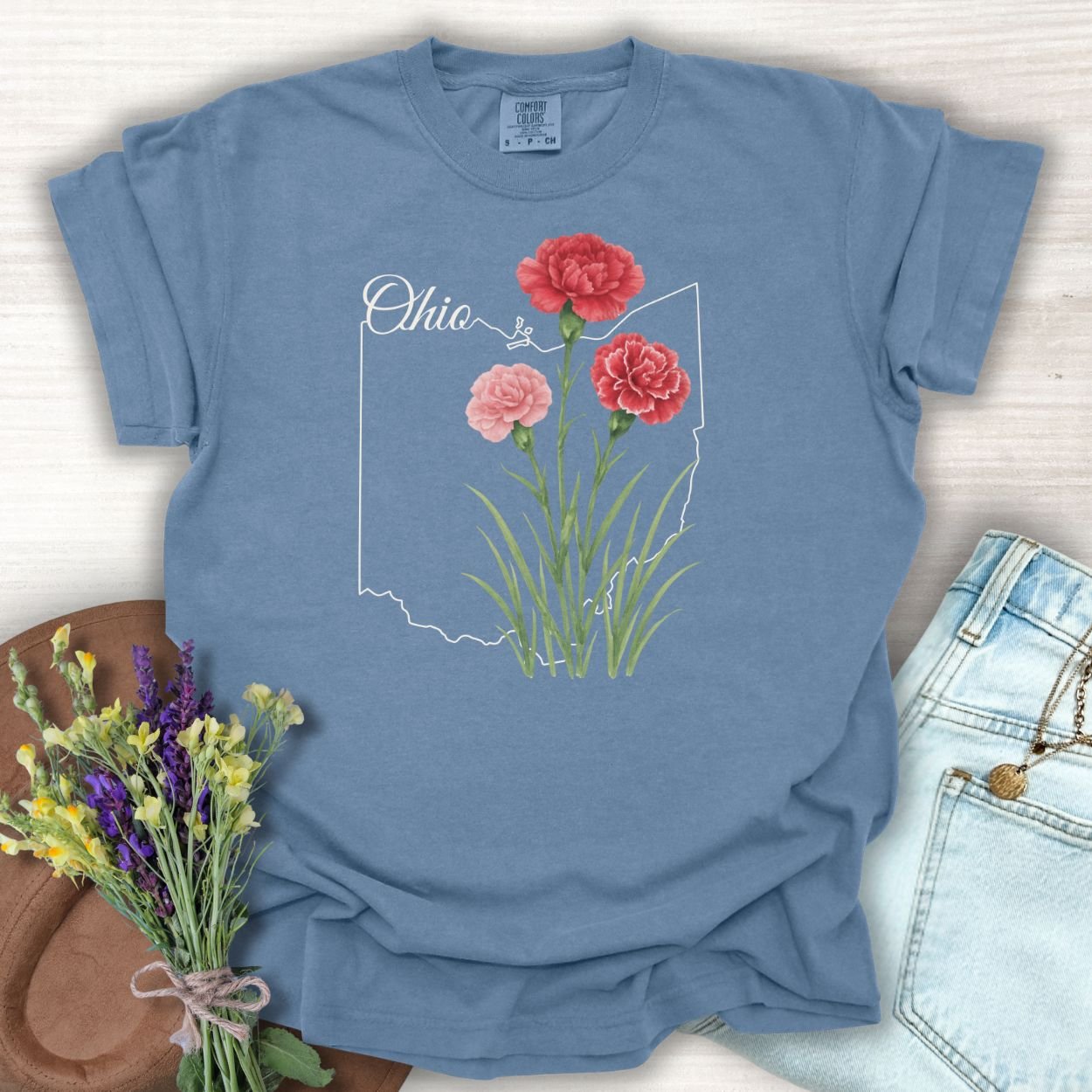 Blue Jean S t-shirt with red and pink carnations layered over a subtle Ohio outline.