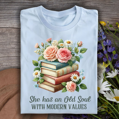 Light blue S t-shirt with watercolor books, pink roses, and "She has an Old Soul WITH MODERN VALUES" text.