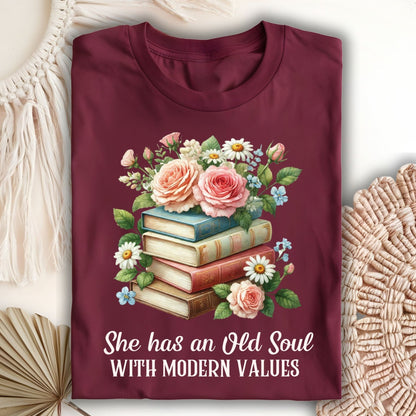 Maroon S t-shirt with watercolor books, roses, and "She has an Old Soul With Modern Values" text.