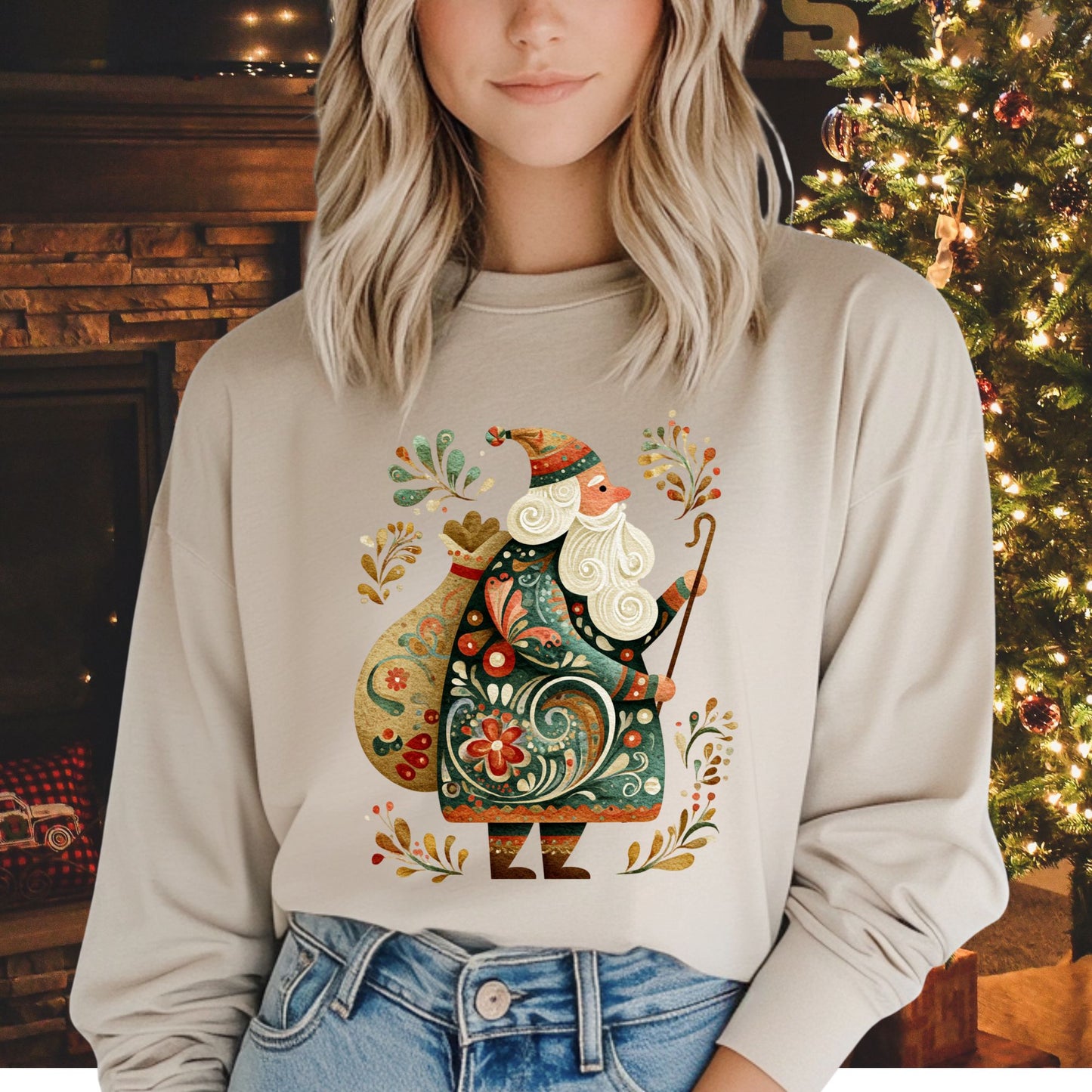 Woman wearing a beige long sleeve tee with an ornate Old World St. Nicholas folk art design.