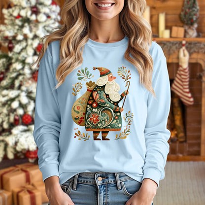 Light blue long sleeve tee with ornate Old World St. Nicholas folk art design, worn by a woman.