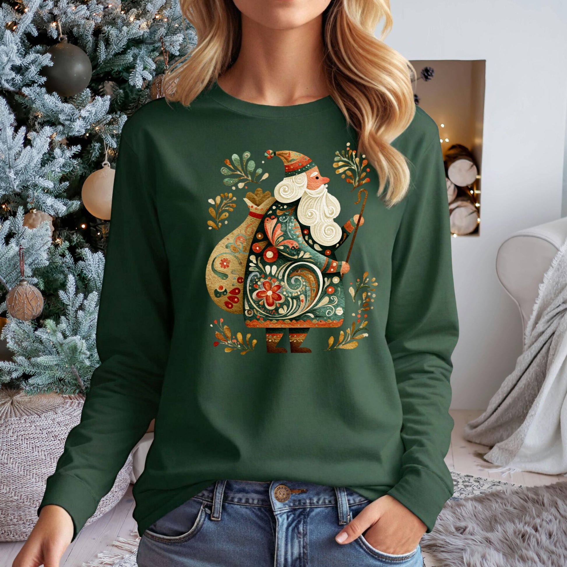 Woman in a dark green long sleeve tee with an ornate Eastern European folk art St. Nicholas design.