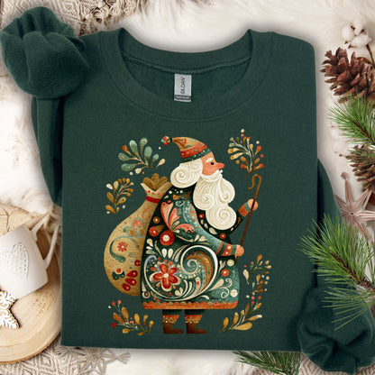 Forest green Gildan sweatshirt with a colorful folk art St. Nicholas design, surrounded by pinecones and fir.