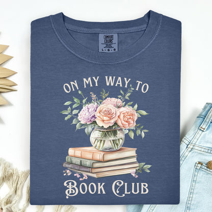Denim t-shirt with "On My Way To Book Club" text, watercolor vintage books, and a vase of pink flowers.
