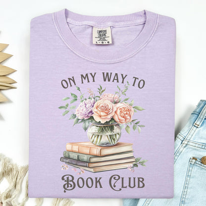 Orchid Comfort Colors t-shirt with "On My Way To Book Club" text, watercolor books, and a vase of pink flowers.