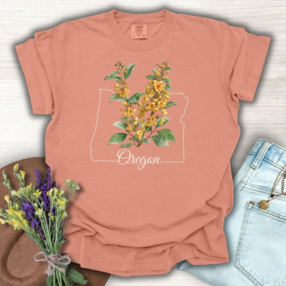 Terracotta S-size t-shirt with a white Oregon state outline and yellow Oregon Grape blossoms.