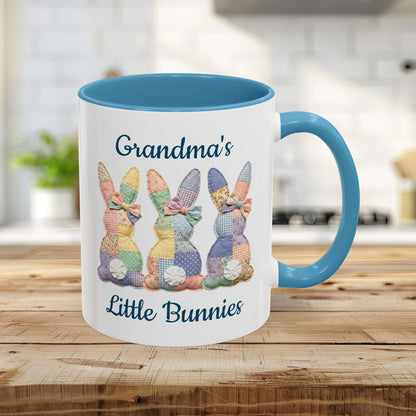 White 11oz ceramic mug with light blue handle/interior, featuring "Grandma's Little Bunnies" and patchwork bunny design.