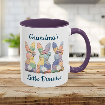 White ceramic mug with purple handle and interior, featuring "Grandma's Little Bunnies" and three patchwork bunnies.