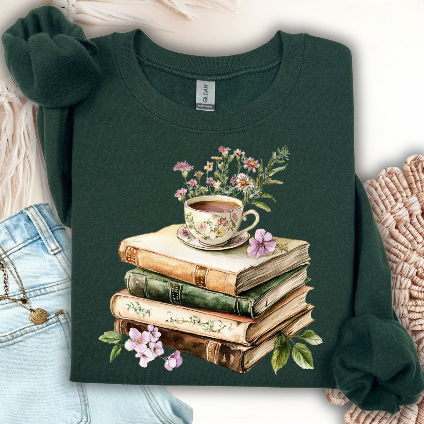 Forest Green crewneck sweatshirt with a vintage illustration of stacked books, a floral teacup, and greenery.