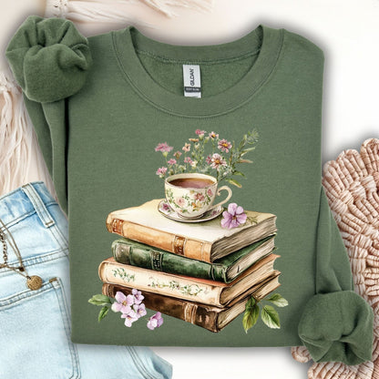 Military Green crewneck sweatshirt with a vintage illustration of stacked books, a floral teacup, and greenery.