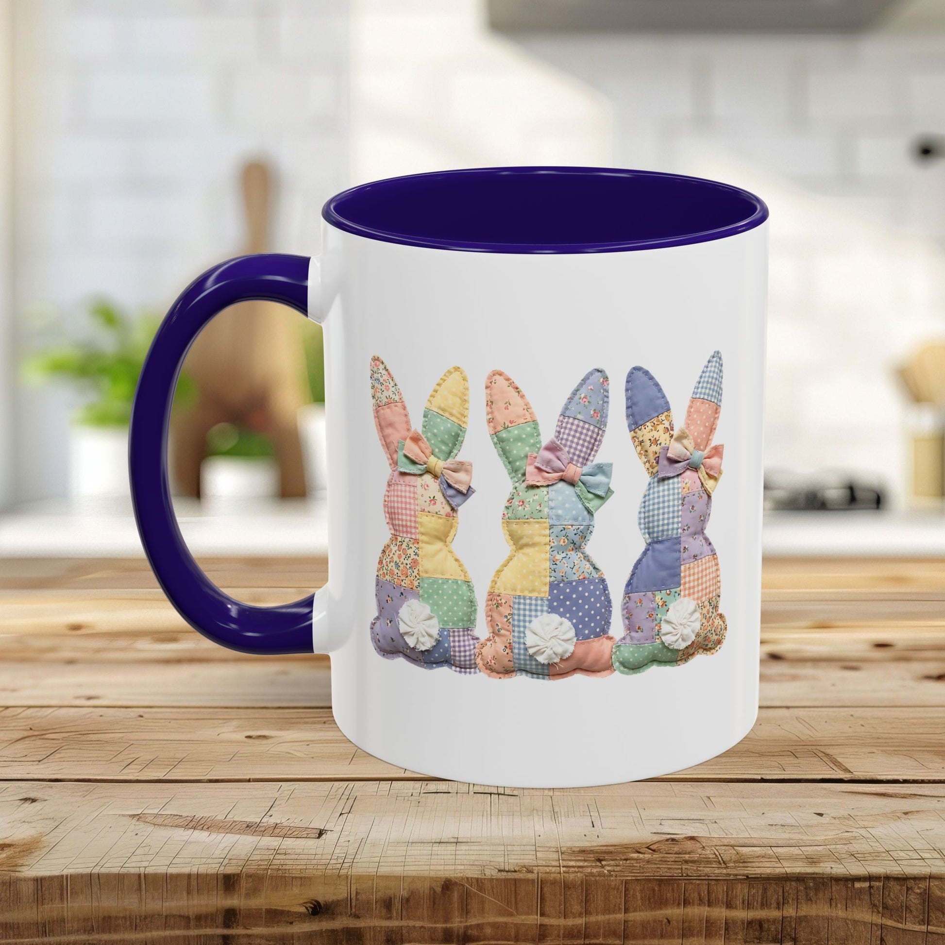 White ceramic mug with a dark purple handle and interior, featuring three pastel patchwork bunnies.