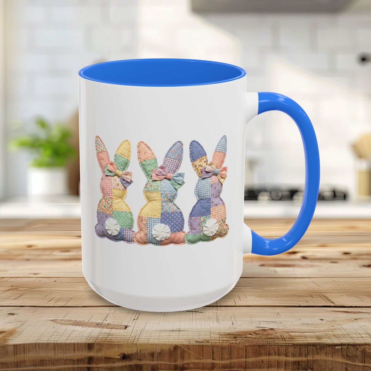 15oz white ceramic mug with Cambridge Blue handle and interior, featuring three pastel patchwork bunnies.