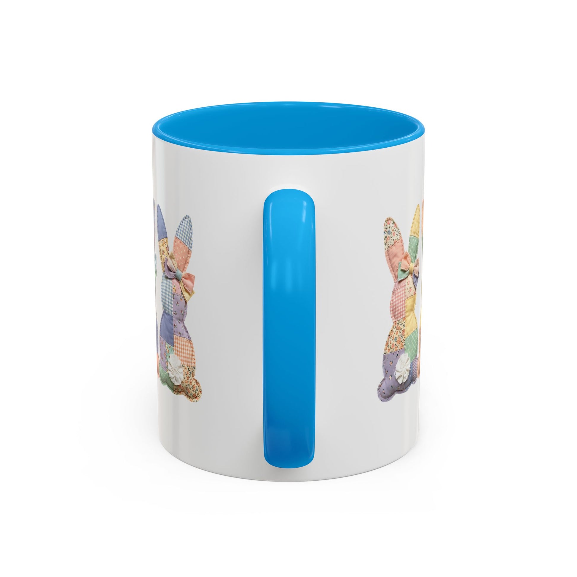White ceramic 11oz mug with blue handle and interior, featuring pastel patchwork bunny tails design.