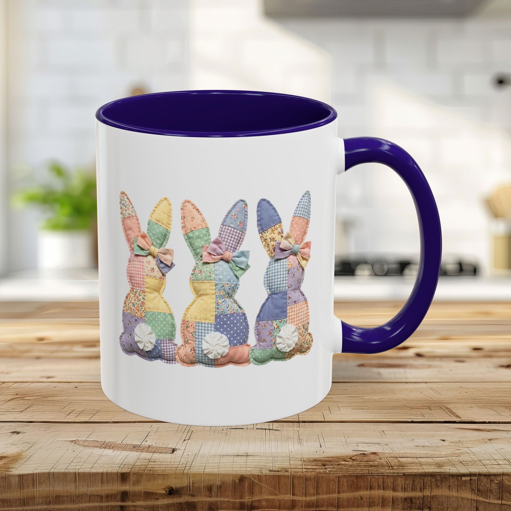 White ceramic mug with a purple handle and interior, featuring three pastel patchwork bunnies.