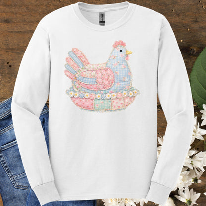 White long-sleeve tee with a pastel faux patchwork hen in a nest of flowers.