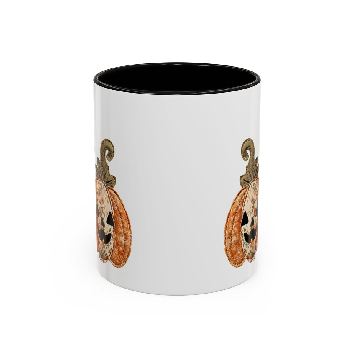 White ceramic mug with black interior and handle, featuring a patchwork Jack O'Lantern design.